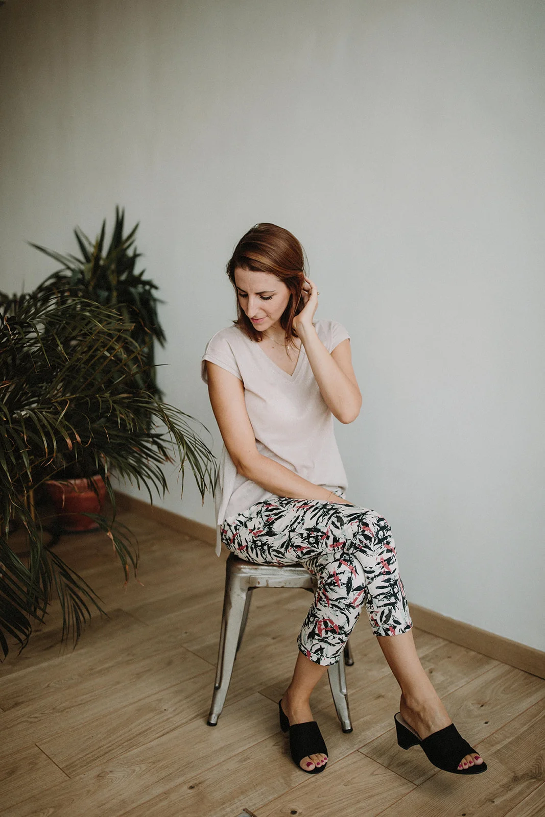 Bianca Topham seated on a stool — resetting energy with a stress management coaching programme
