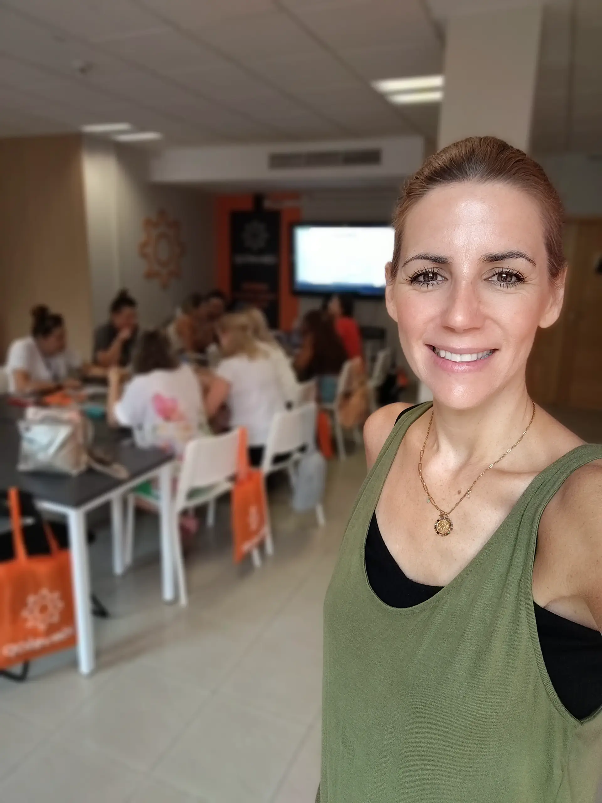 Bianca Topham smiling during a wellbeing workshop with clients
