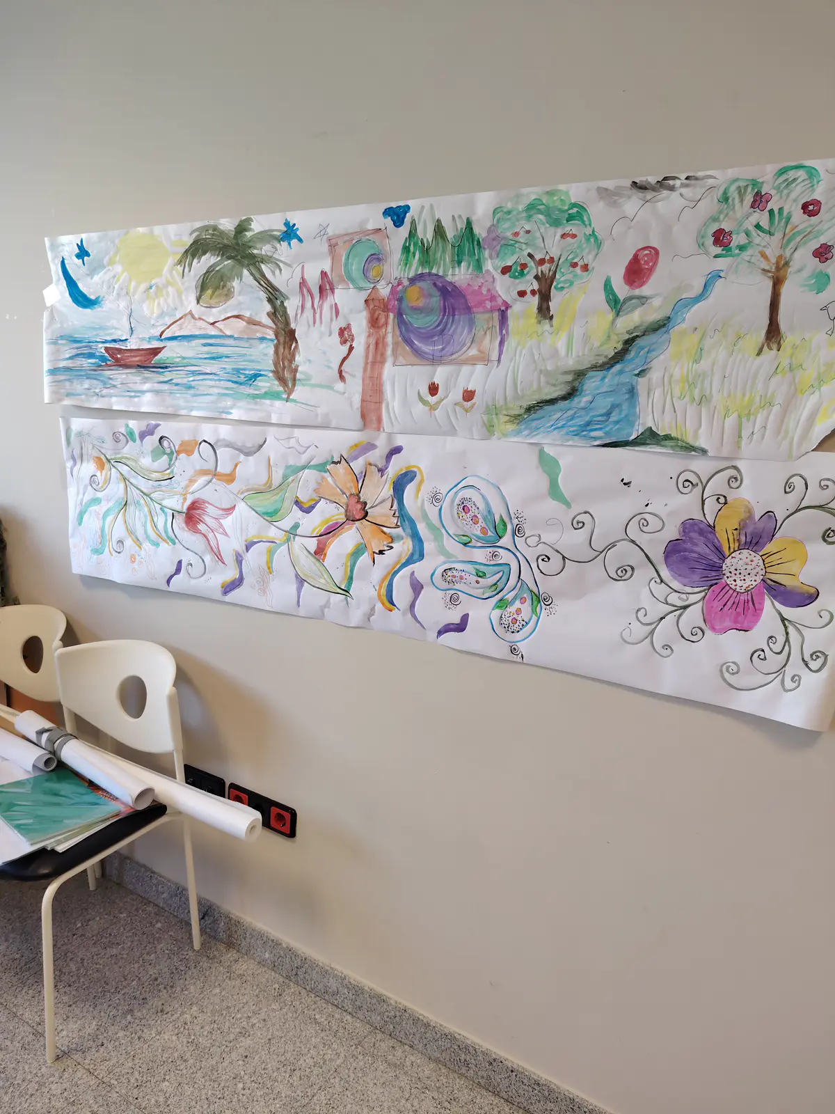 Colourful group paintings made during art for wellbeing sessions